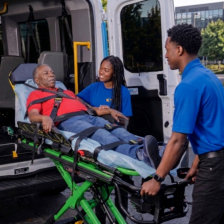 A man is being transported on a stretcher by paramedics into an ambulance for medical assistance.