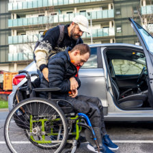 man assist the man in a wheelchair