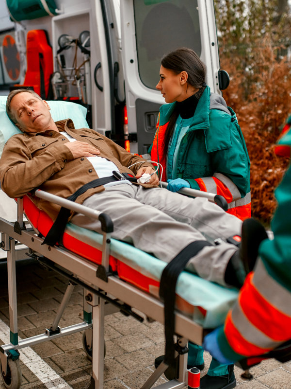 caregiver assist the man in a wheelchair