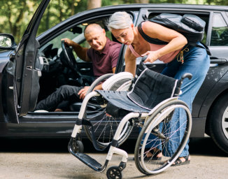 woman folding a wheelchair
