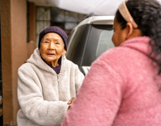 caregiver assist the elderly woman